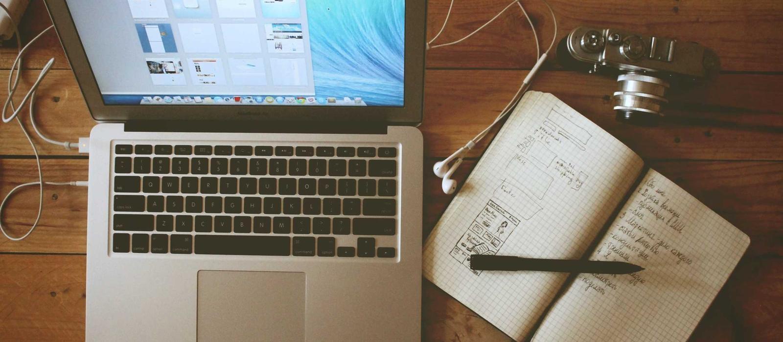 Desk with paperwork and a laptop, representing organised bookkeeping