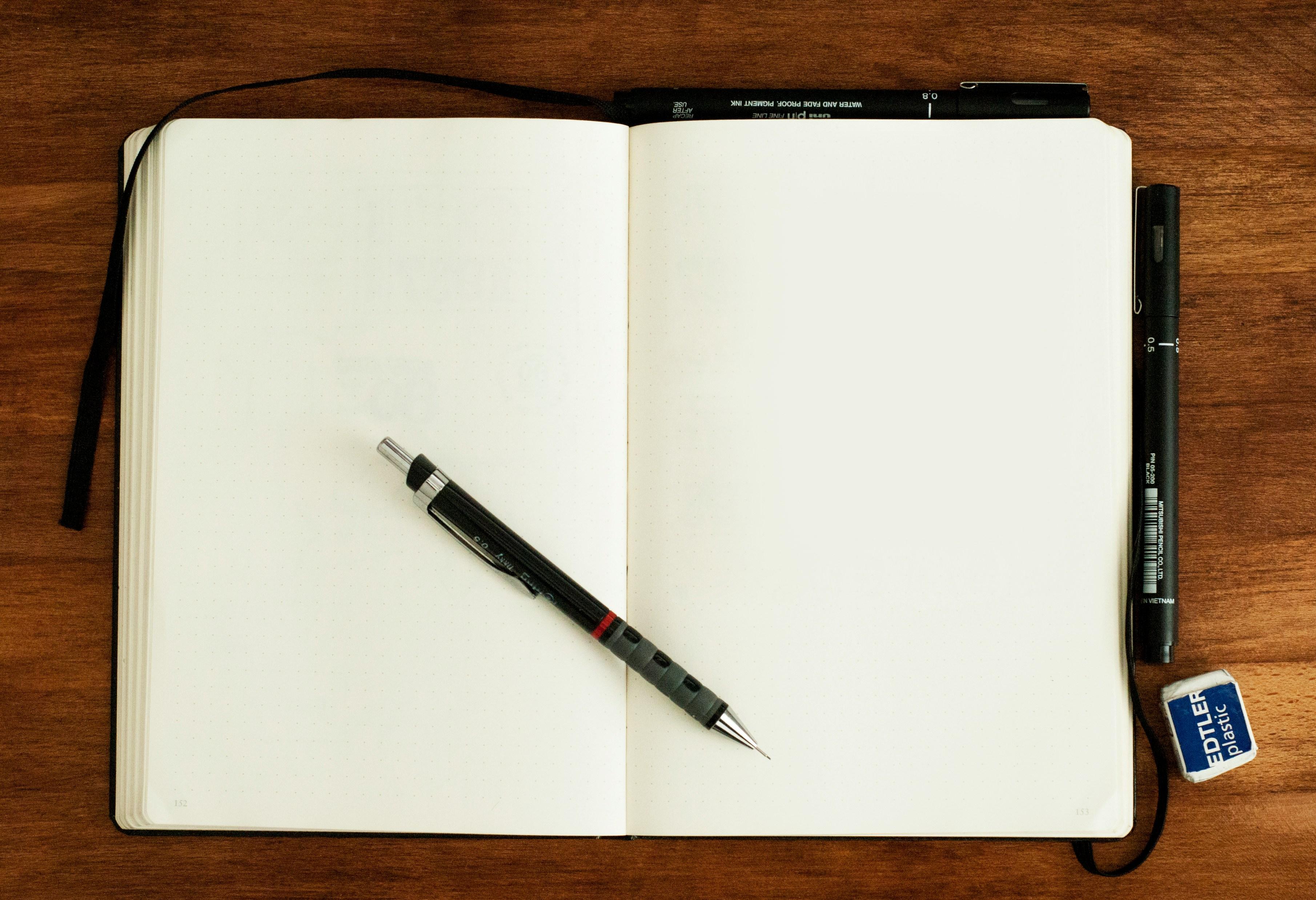 Open notebook and pen, representing practical guides and checklists