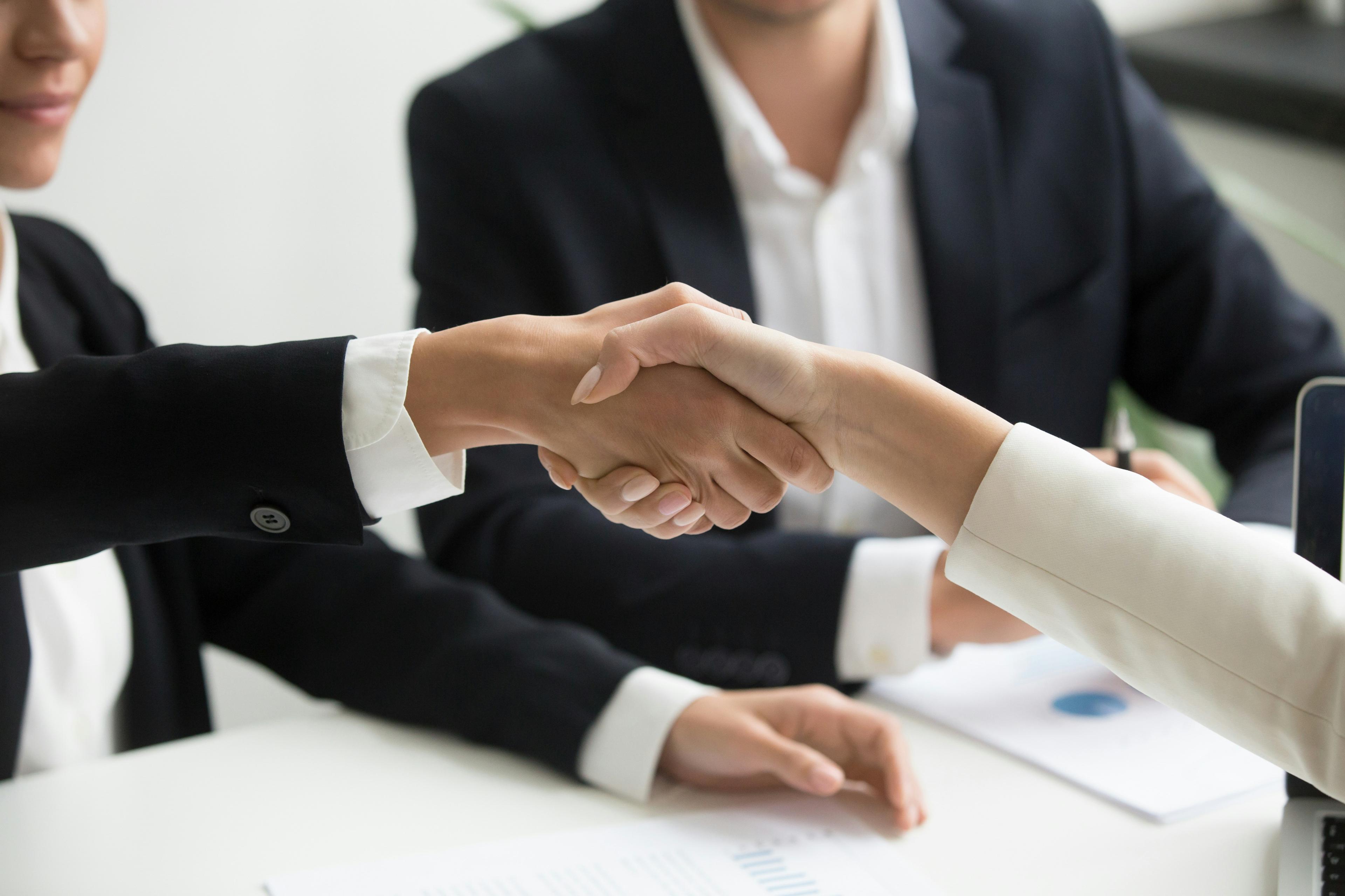 Handshake moment representing client trust and satisfaction